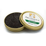 Open tin of Da Vinci Royal caviar displaying glossy dark brown pearls with smooth texture and medium size.