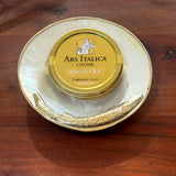 Handcrafted mother-of-pearl caviar dish shaped like a sturgeon, with silver or gold metallic trim, designed for luxury caviar service and elegant table presentation.
