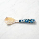 Handcrafted mother of pearl caviar spoon with a sea blue handle, designed for elegant serving of premium caviar.
